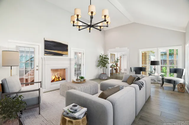 a living room with furniture a fireplace and a flat screen tv