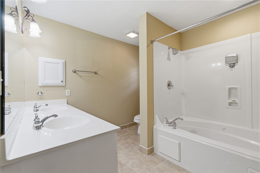 204 Butler Avenue Greenville, SC 29601 - Photo 23 of 26 Dual vanity sinks provide ample space in this well-appointed bathroom, featuring a combined tub and shower.