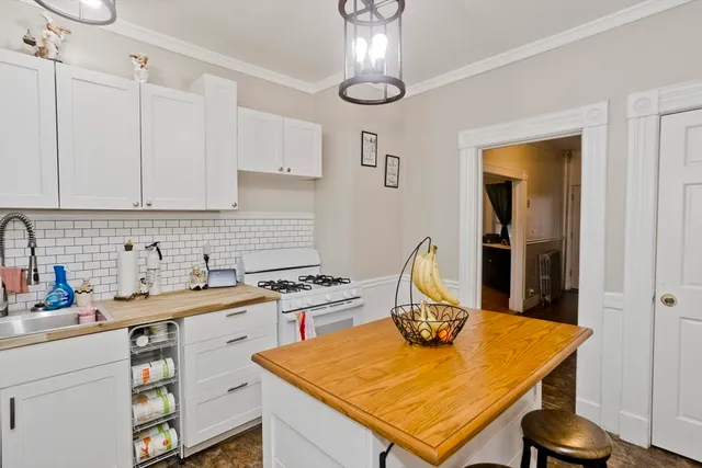 a view of a kitchen with a sink and cabinet