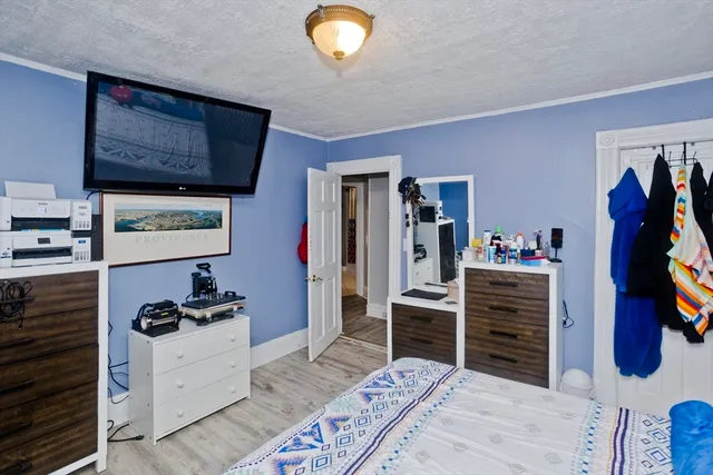 a bedroom with a bed and a chandelier