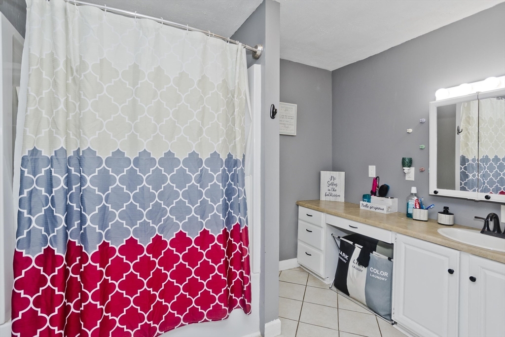 37 Phoenix Street Springfield, MA 01104 - Photo 22 of 39 a bathroom with a sink a vanity and a mirror