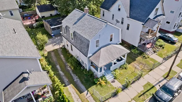 an aerial view of a house with a yard