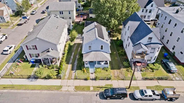 an aerial view of a house with a yard