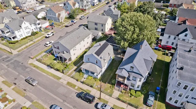 an aerial view of a house with a yard