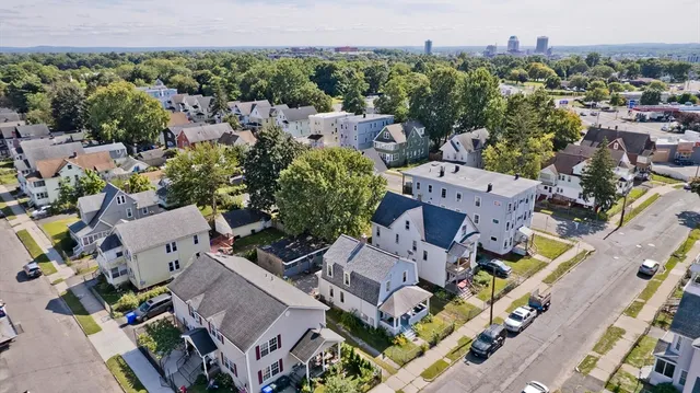 an aerial view of multiple houses with yard
