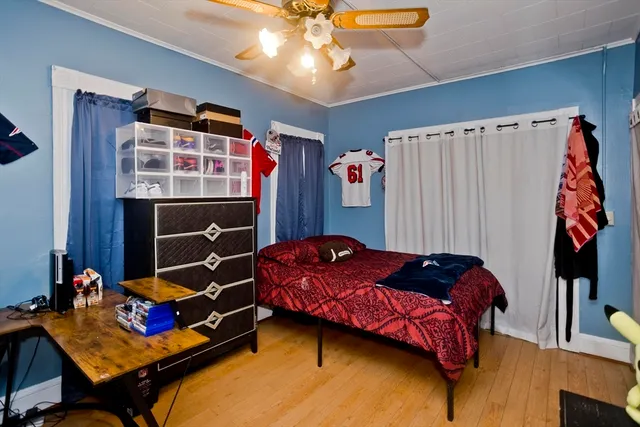 a bedroom with a bed and a window