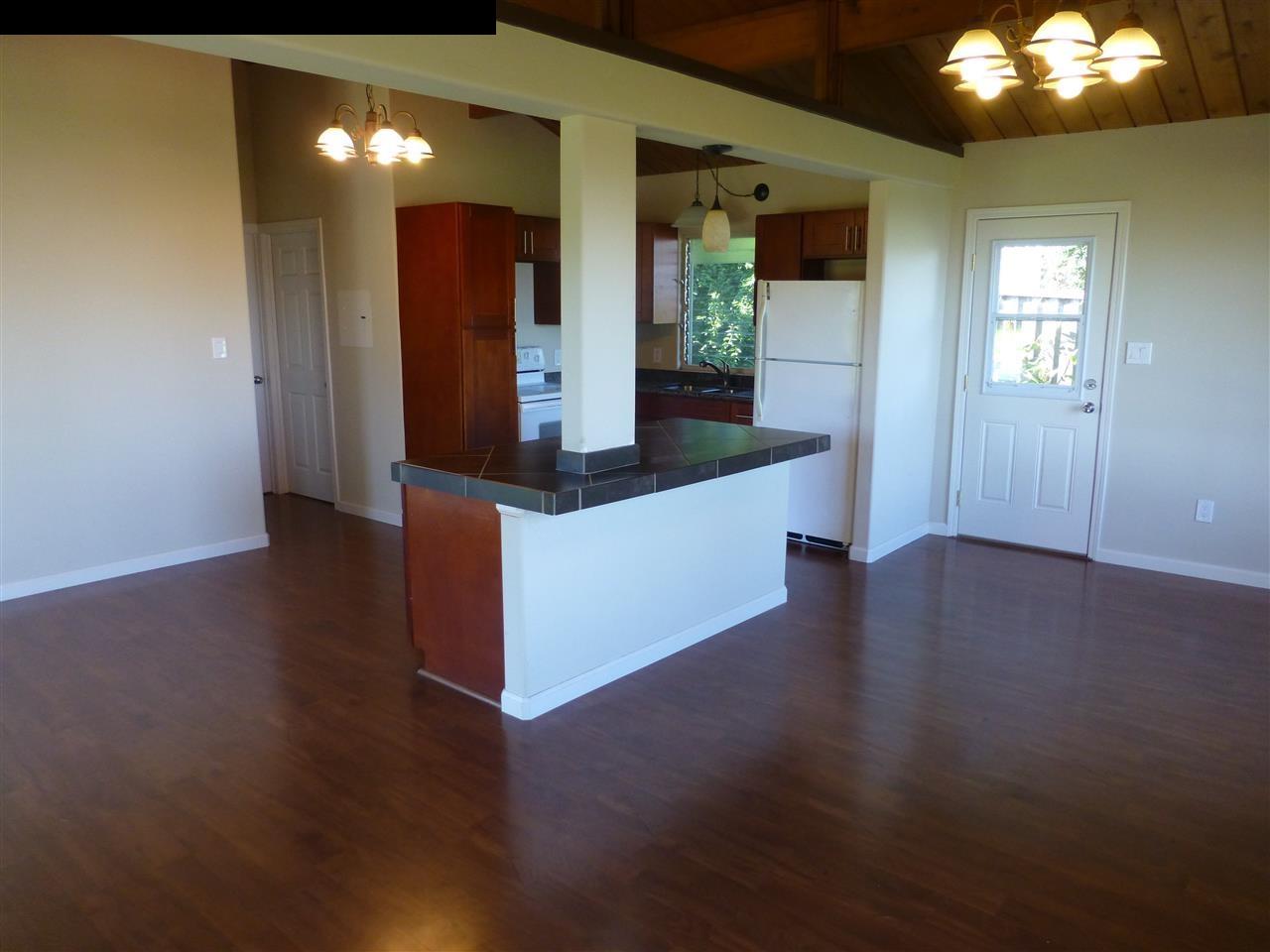 5821 Lower Kula Road Kula, HI 96790 - Photo 11 of 27 a kitchen view with wooden floor and staircase