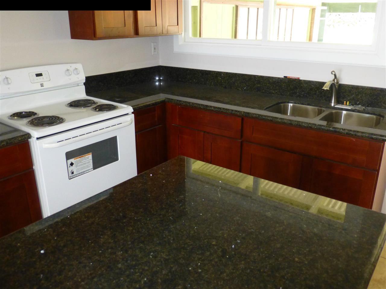 5821 Lower Kula Road Kula, HI 96790 - Photo 3 of 27 a kitchen with a sink and cabinets