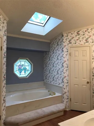 a bathroom with a bathtub and a window