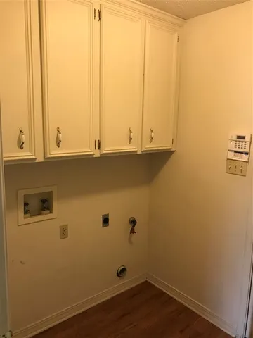 a view of cabinets and wooden floor