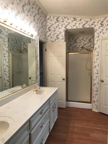 a bathroom with a double vanity sink and mirror