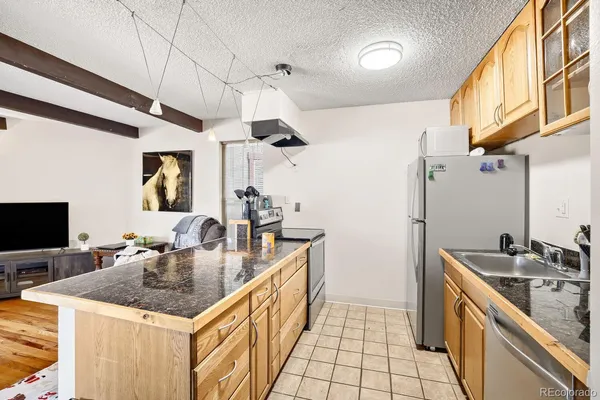 a kitchen with a sink a counter top space and cabinets
