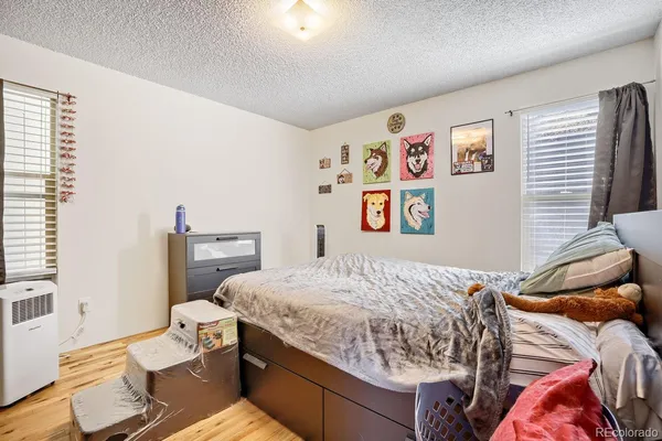 a bedroom with a bed and a desk