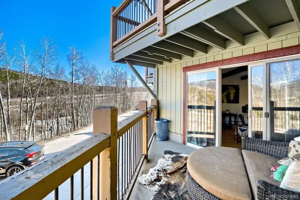 a view of balcony with wooden floor and outdoor seating
