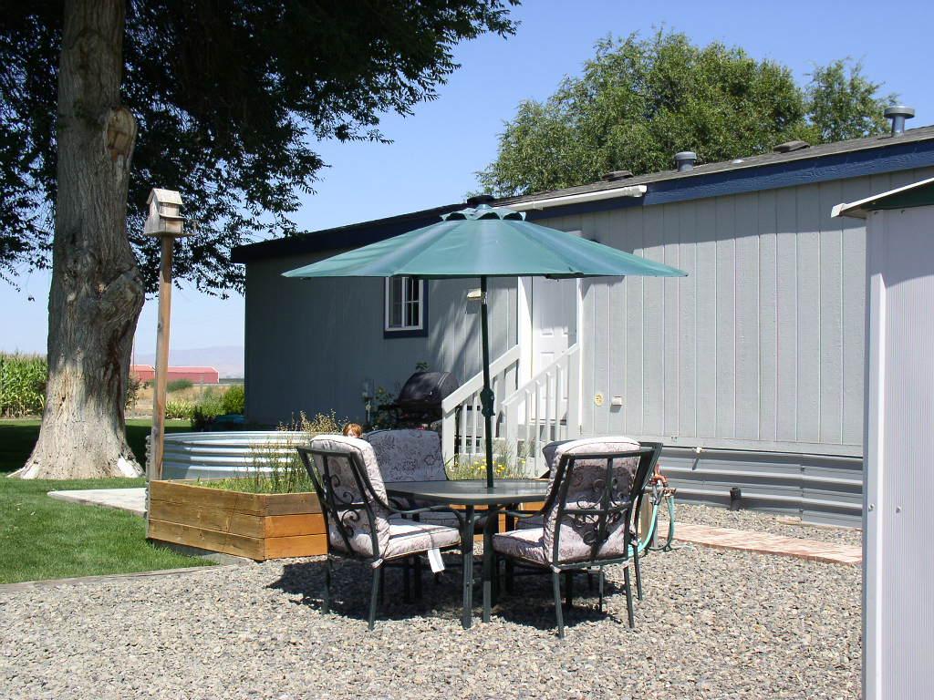 8190 Campbell Road Toppenish, WA 98948 - Photo 12 of 18 a view of a patio with table and chairs under an umbrella