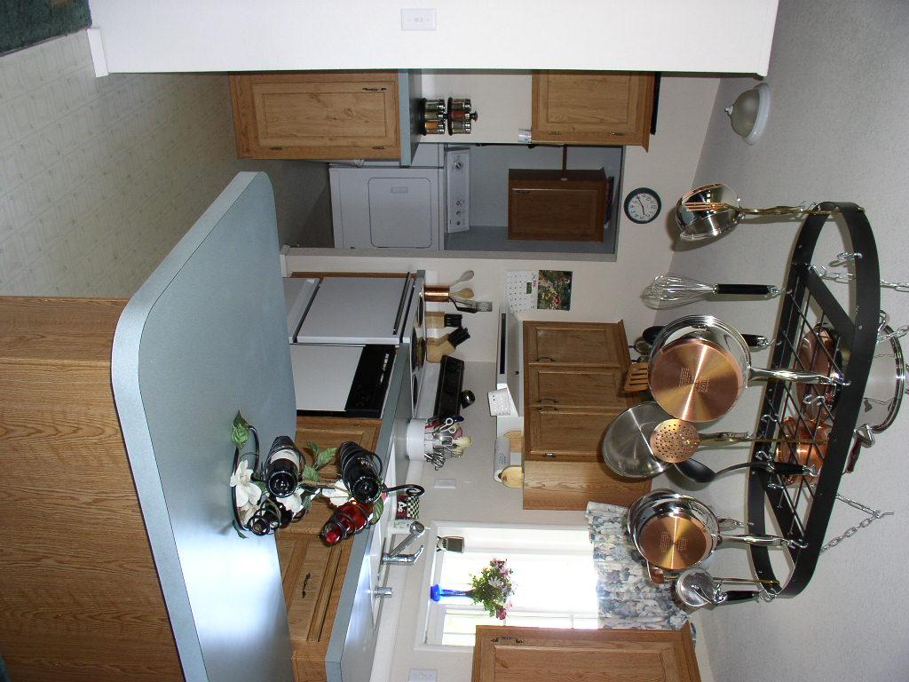 8190 Campbell Road Toppenish, WA 98948 - Photo 10 of 18 a kitchen with a sink a stove and a stove with wooden floor