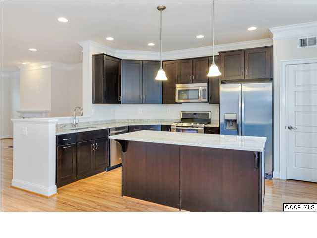 2315 Avinity Loop Charlottesville, VA 22902 - Photo 6 of 23 a kitchen with kitchen island granite countertop wooden cabinets and a stainless steel appliances