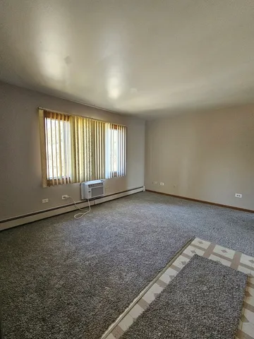 an empty room with a empty space and windows