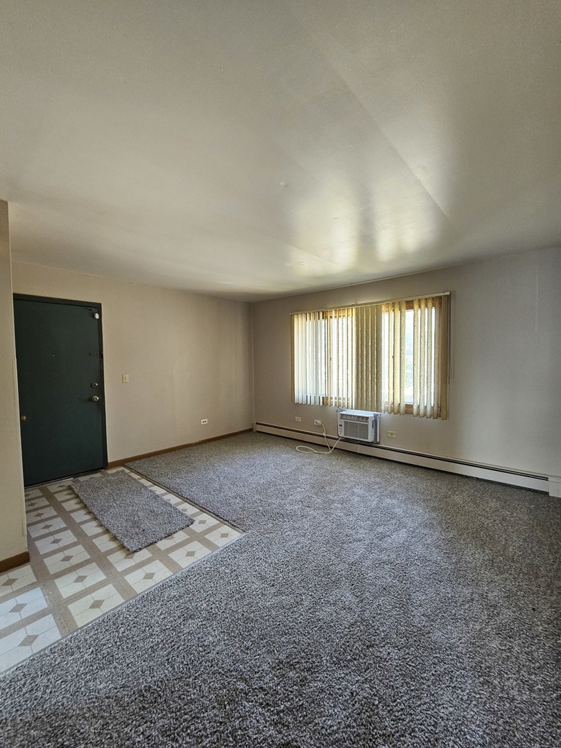 1335 Abbott Drive, Unit 5 Elgin, IL 60123 - Photo 4 of 10 a view of an empty room with a window