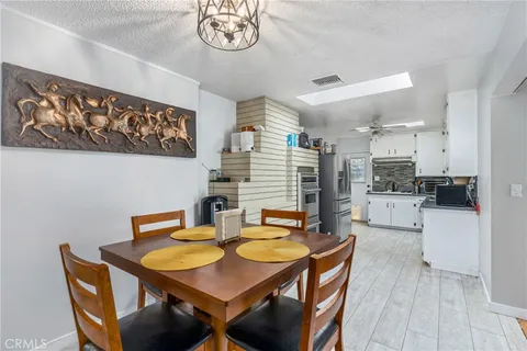 a view of a dining room with furniture and a kitchen
