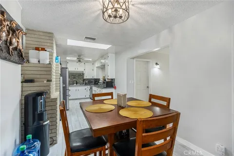 a view of a dining room with furniture and a kitchen
