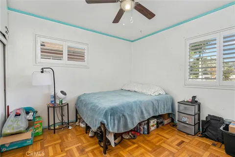 a bedroom with a bed dresser and a window