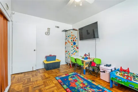 a bedroom with a bed and a wooden floor