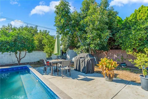 swimming pool view with a garden space