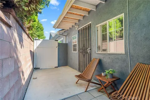 a view of porch with a chair and potted plant