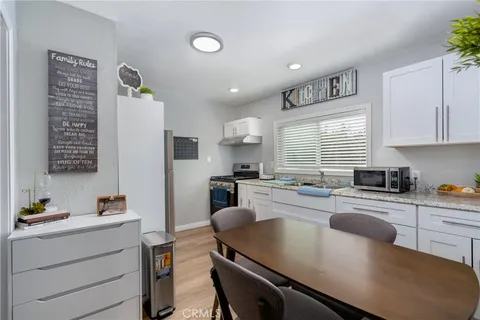 a kitchen with a table chairs stove and cabinets