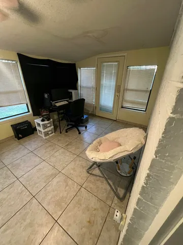 a view of a livingroom with chairs and a rug