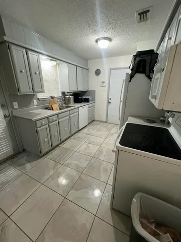 a view of a workspace with furniture