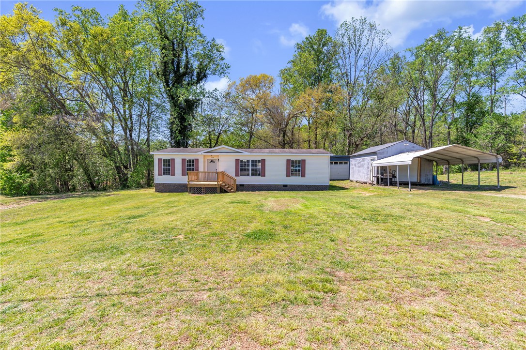 A charming single-story home with ample outdoor space and mature trees.