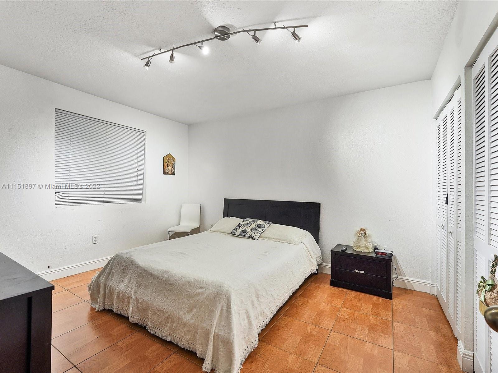 23 Northeast 46th Street Miami, FL 33137 - Photo 16 of 27 a bed room with a bed and a tv