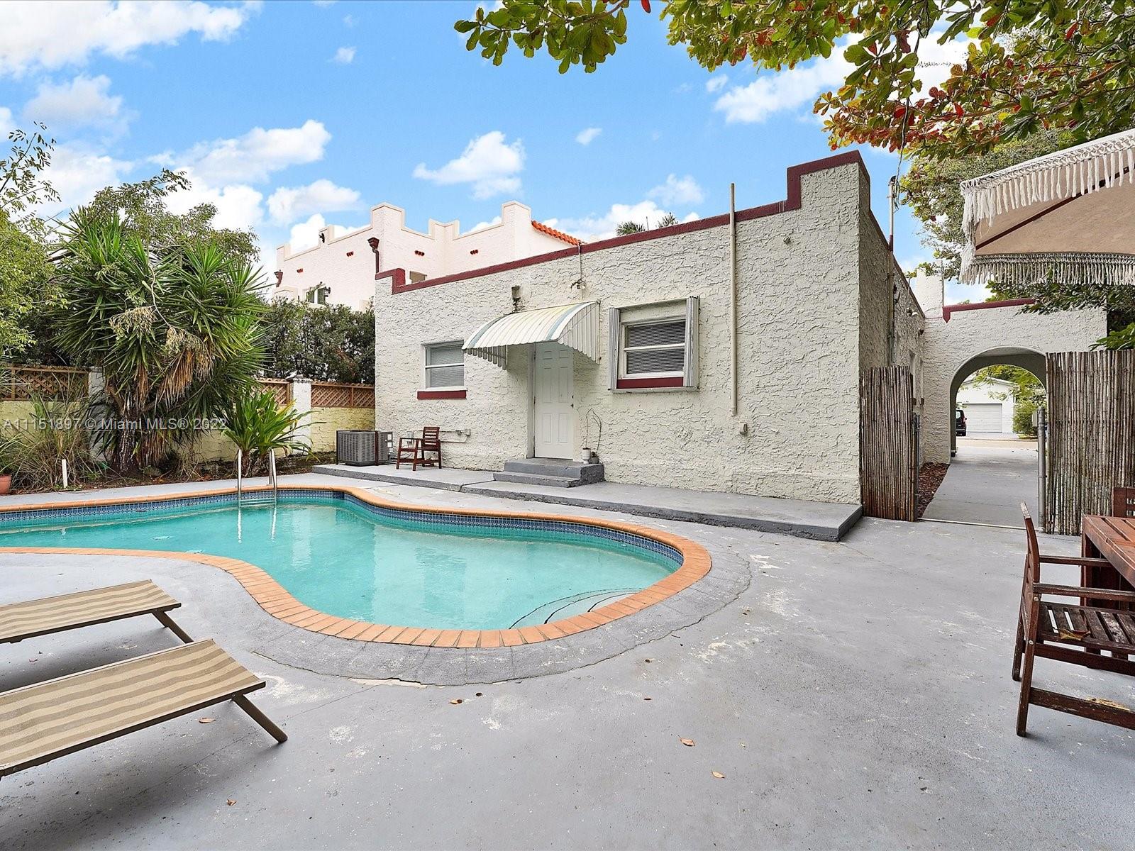 23 Northeast 46th Street Miami, FL 33137 - Photo 17 of 27 a view of a swimming pool with a patio