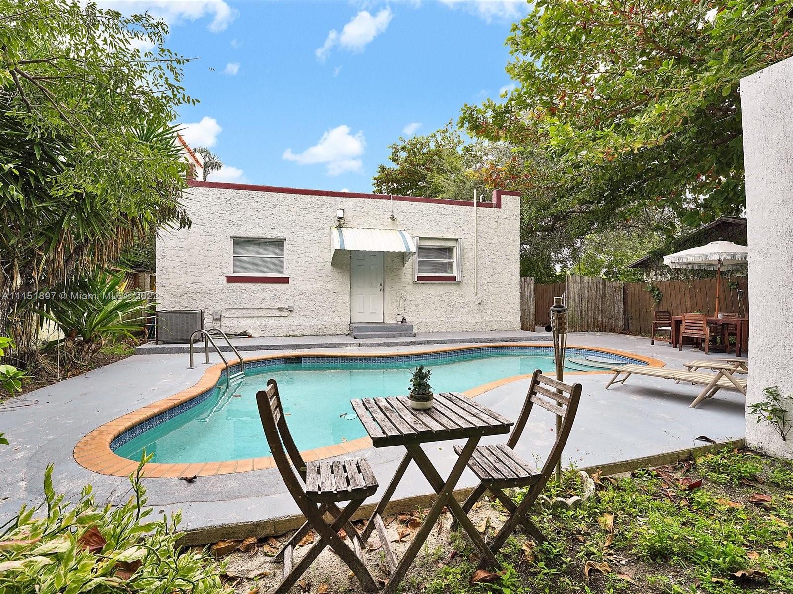 23 Northeast 46th Street Miami, FL 33137 - Photo 19 of 27 a swimming pool with outdoor seating and yard