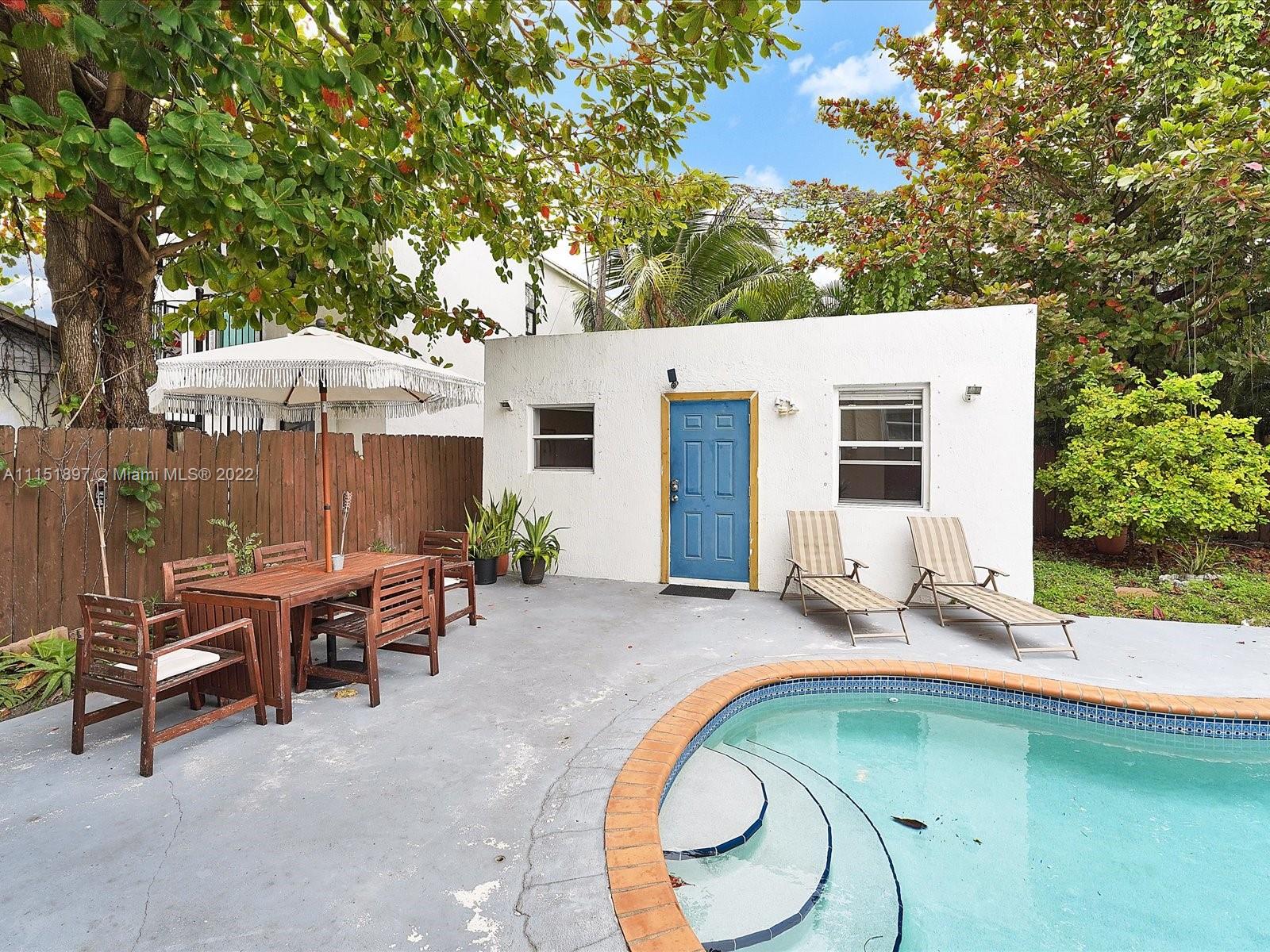 23 Northeast 46th Street Miami, FL 33137 - Photo 20 of 27 a backyard of a house with table and chairs