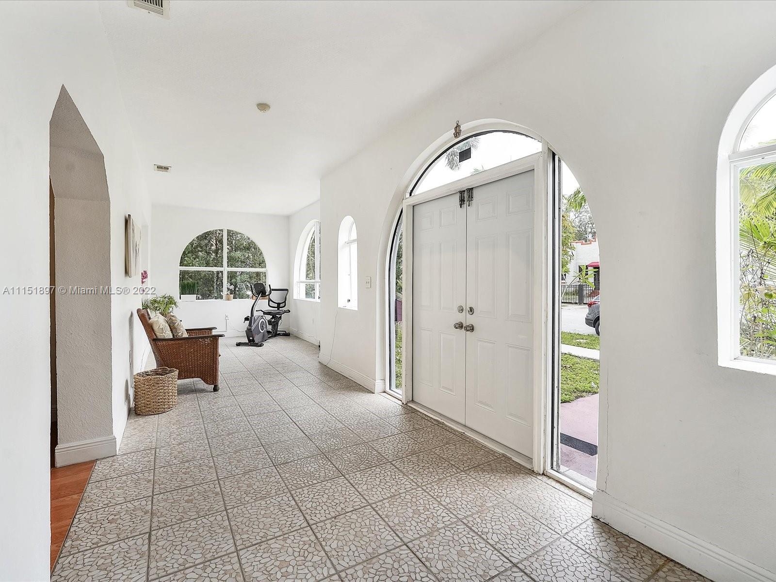 23 Northeast 46th Street Miami, FL 33137 - Photo 2 of 27 a living room with furniture and a fireplace