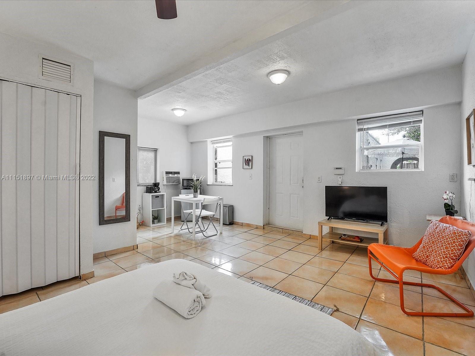 23 Northeast 46th Street Miami, FL 33137 - Photo 23 of 27 a living room with furniture and a flat screen tv