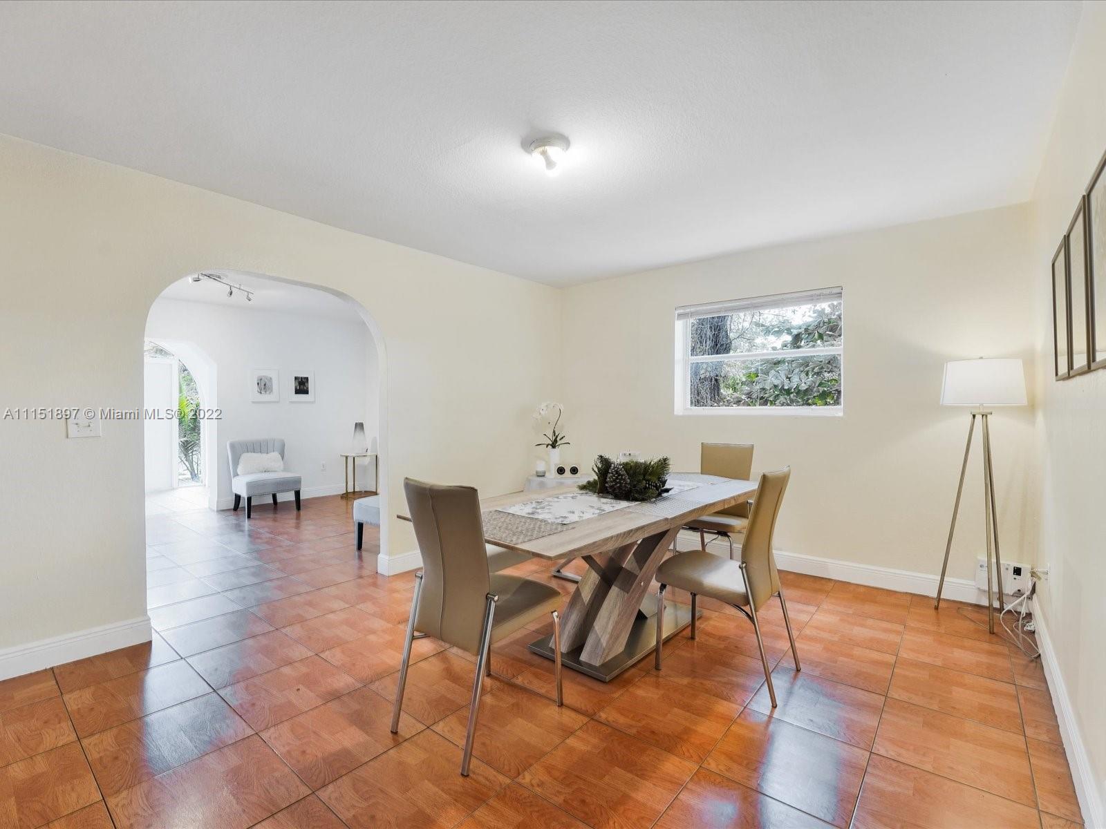 23 Northeast 46th Street Miami, FL 33137 - Photo 9 of 27 a view of a dining room with furniture and a wooden floor