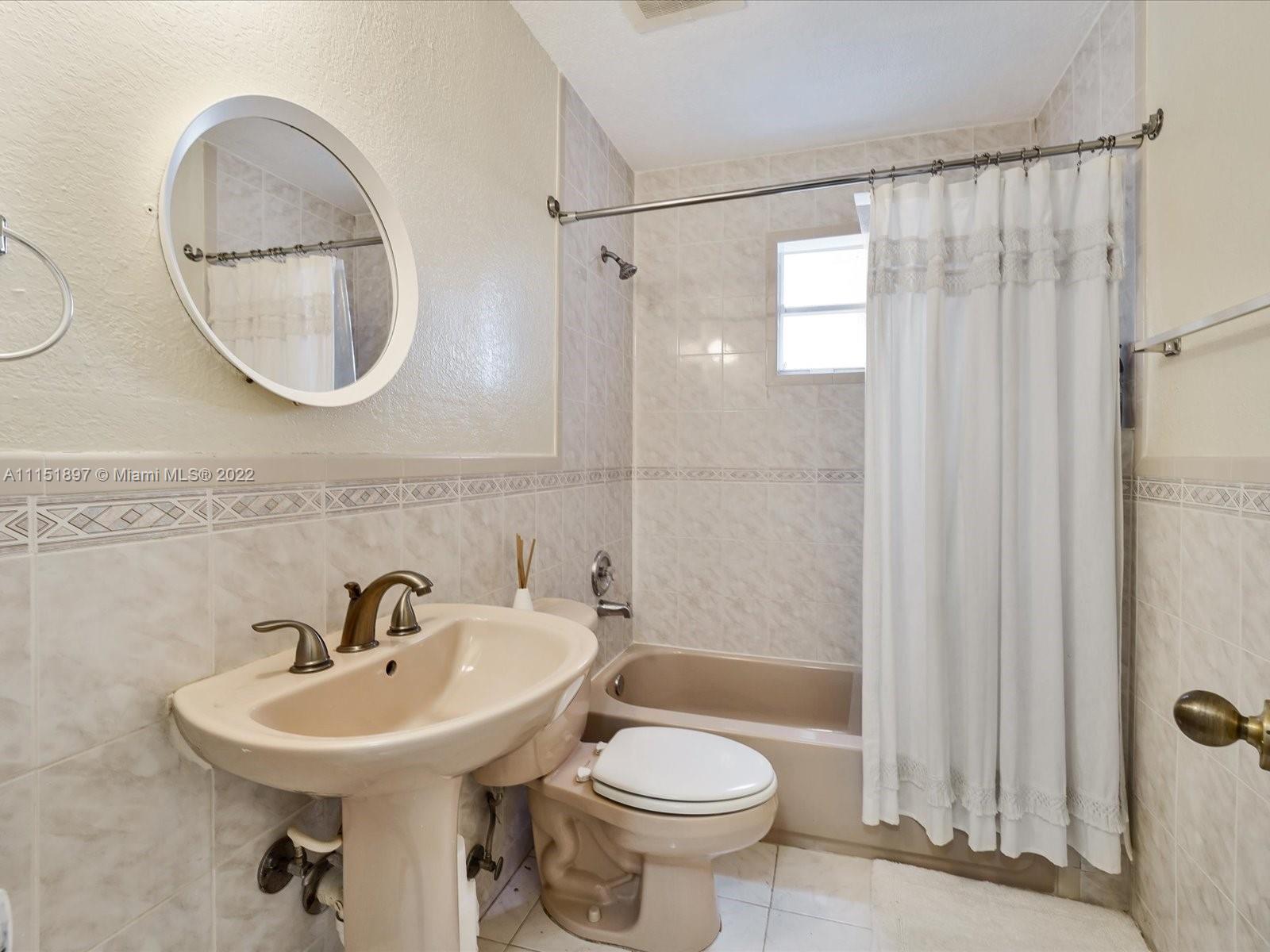 23 Northeast 46th Street Miami, FL 33137 - Photo 10 of 27 a bathroom with a sink toilet and a mirror