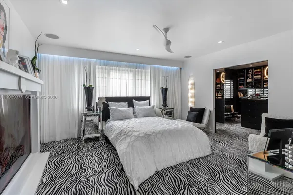 a bedroom with a bed a table and chair