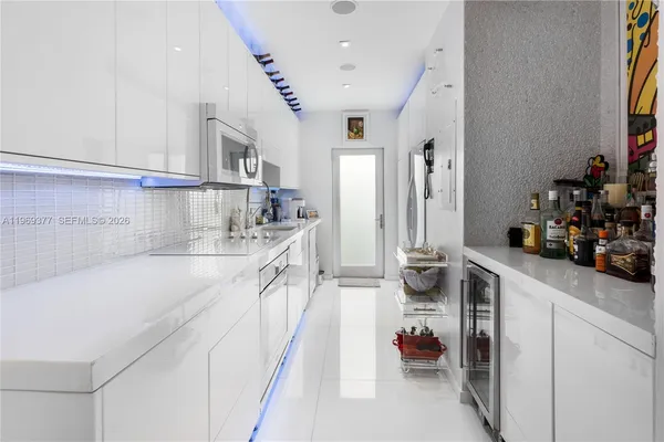 a kitchen with a sink and a refrigerator