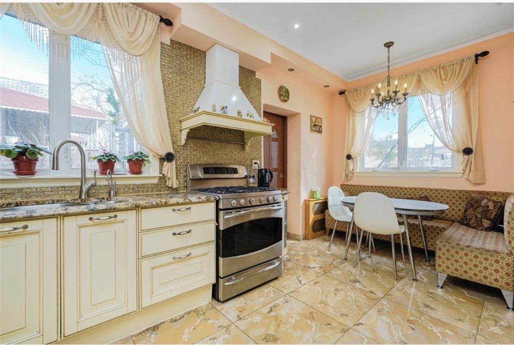 2623 Ave Y Brooklyn, NY 11235 - Photo 11 of 35 a kitchen with stainless steel appliances kitchen island granite countertop a sink and cabinets