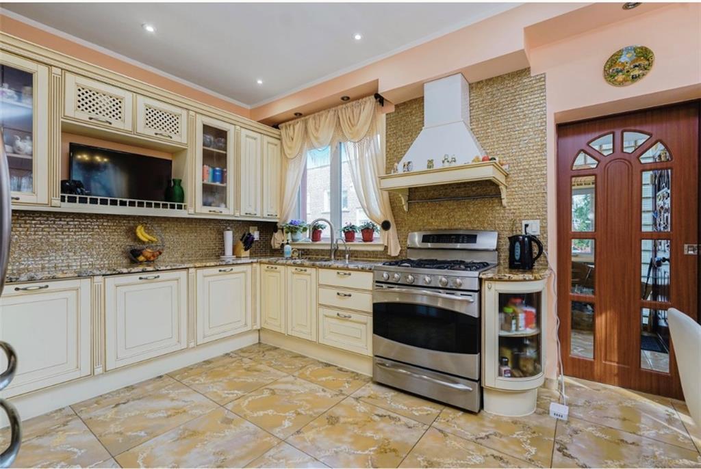 2623 Ave Y Brooklyn, NY 11235 - Photo 12 of 35 a kitchen with stainless steel appliances granite countertop a stove top oven a sink a counter space and cabinets