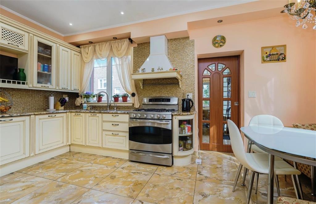 2623 Ave Y Brooklyn, NY 11235 - Photo 13 of 35 a kitchen with a stove a sink and a refrigerator