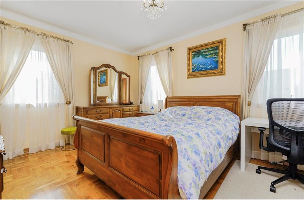 2623 Ave Y Brooklyn, NY 11235 - Photo 19 of 35 a bedroom with a bed and a dresser in it