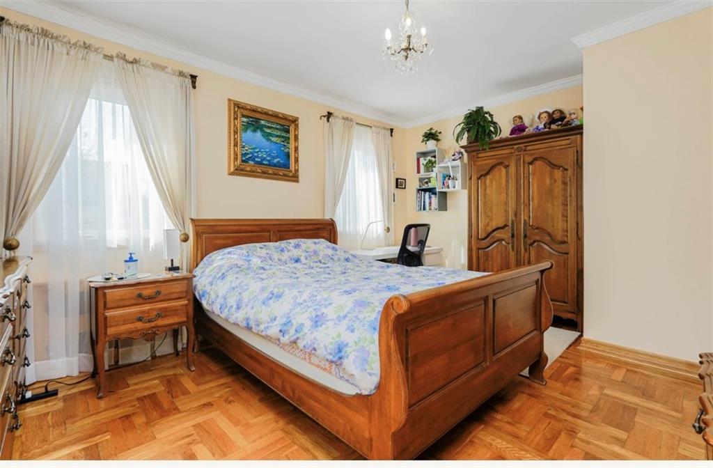 2623 Ave Y Brooklyn, NY 11235 - Photo 23 of 35 a bedroom with a bed and a window