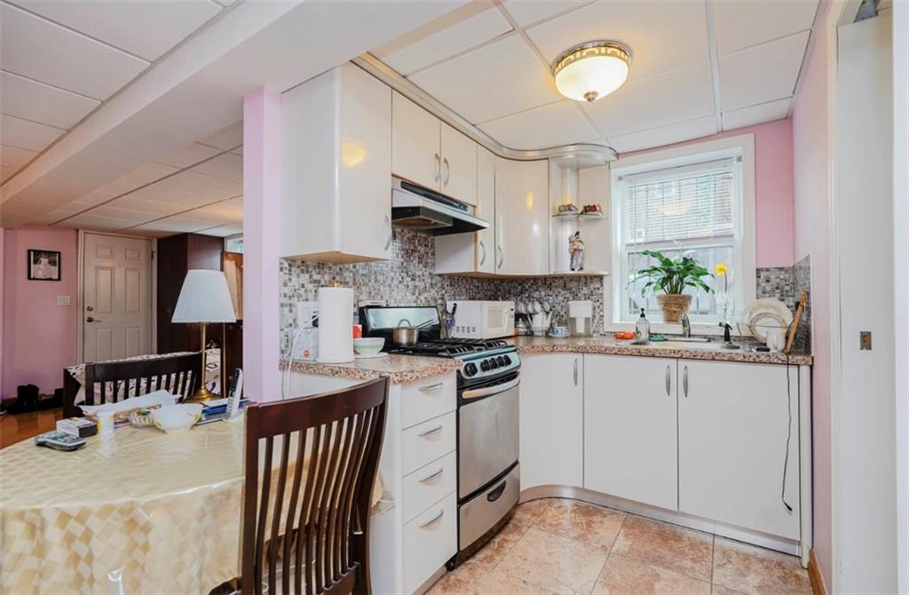 2623 Ave Y Brooklyn, NY 11235 - Photo 24 of 35 a kitchen with stainless steel appliances granite countertop a sink and cabinets