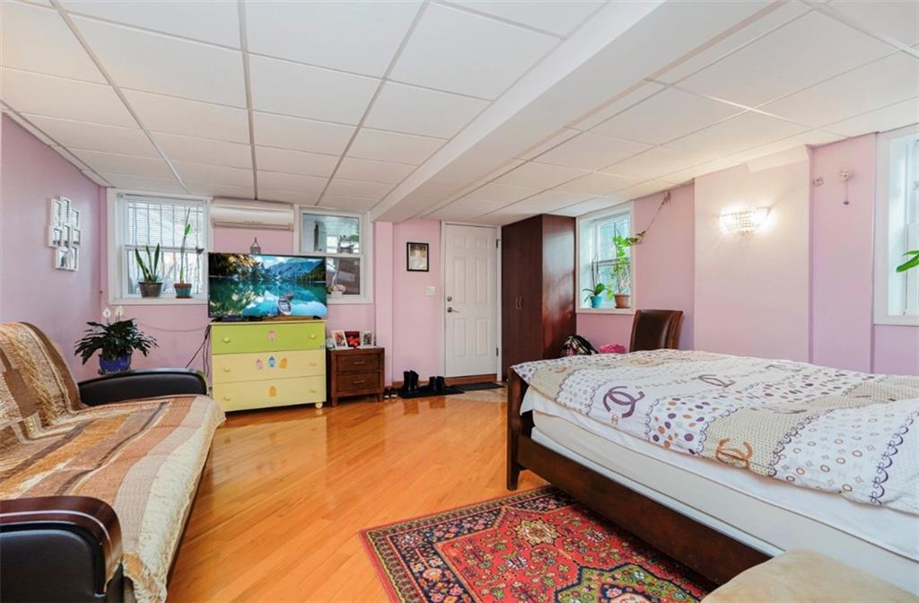 2623 Ave Y Brooklyn, NY 11235 - Photo 25 of 35 a bed room with a bed window and a flat screen tv